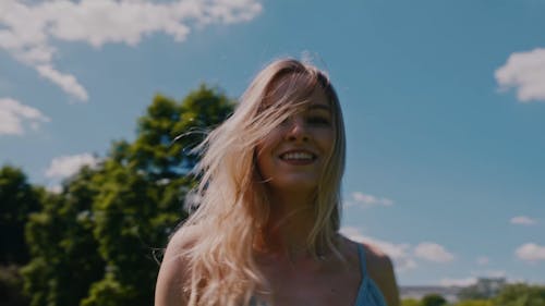 An Arc Shot of a Woman Modeling in a Park