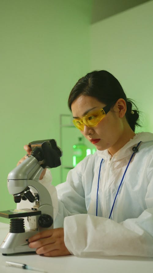 A Female Scientist Using a Microscope