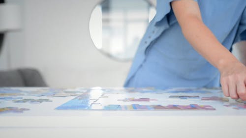 Person Completing A Jigsaw Puzzle