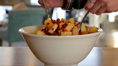 mixing fruit on a bowl