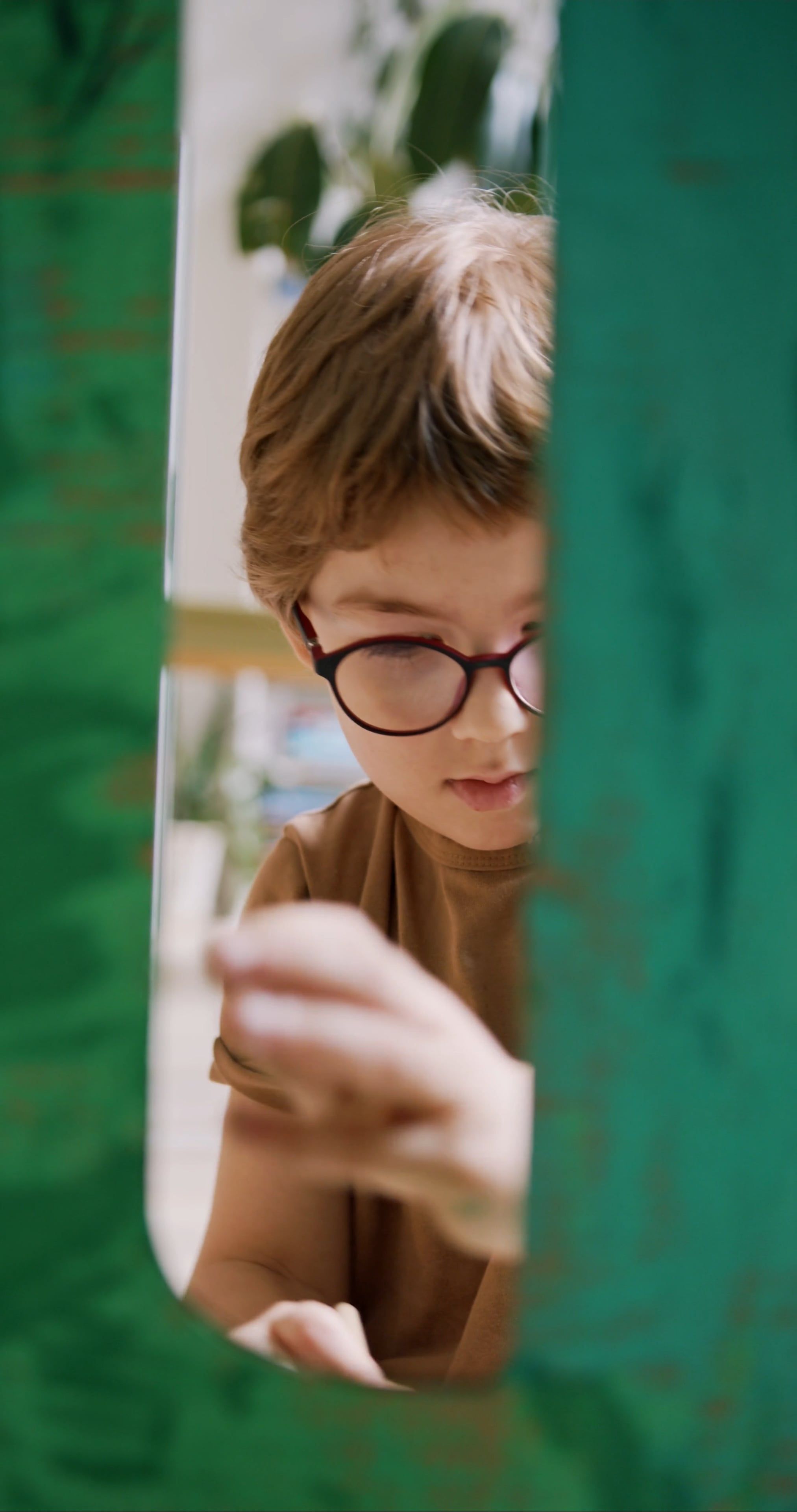 a-young-boy-wearing-eyeglasses-while-painting-free-stock-video