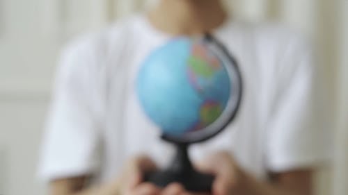 Person Holding Globe