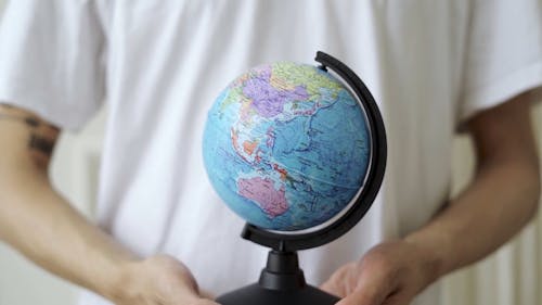 Person Holding Globe