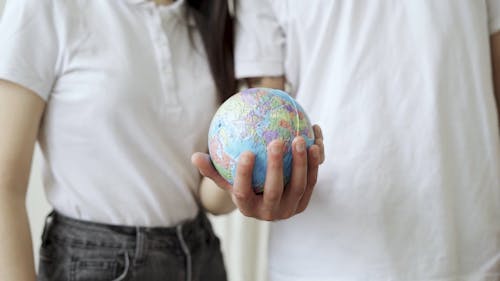 Person Holding Globe