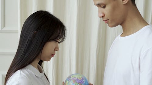 Two People holding Globe