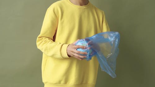 A Man Holding a Globe and a Plastic