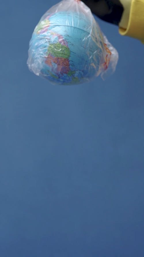 Person Holding a Plastic with Globe