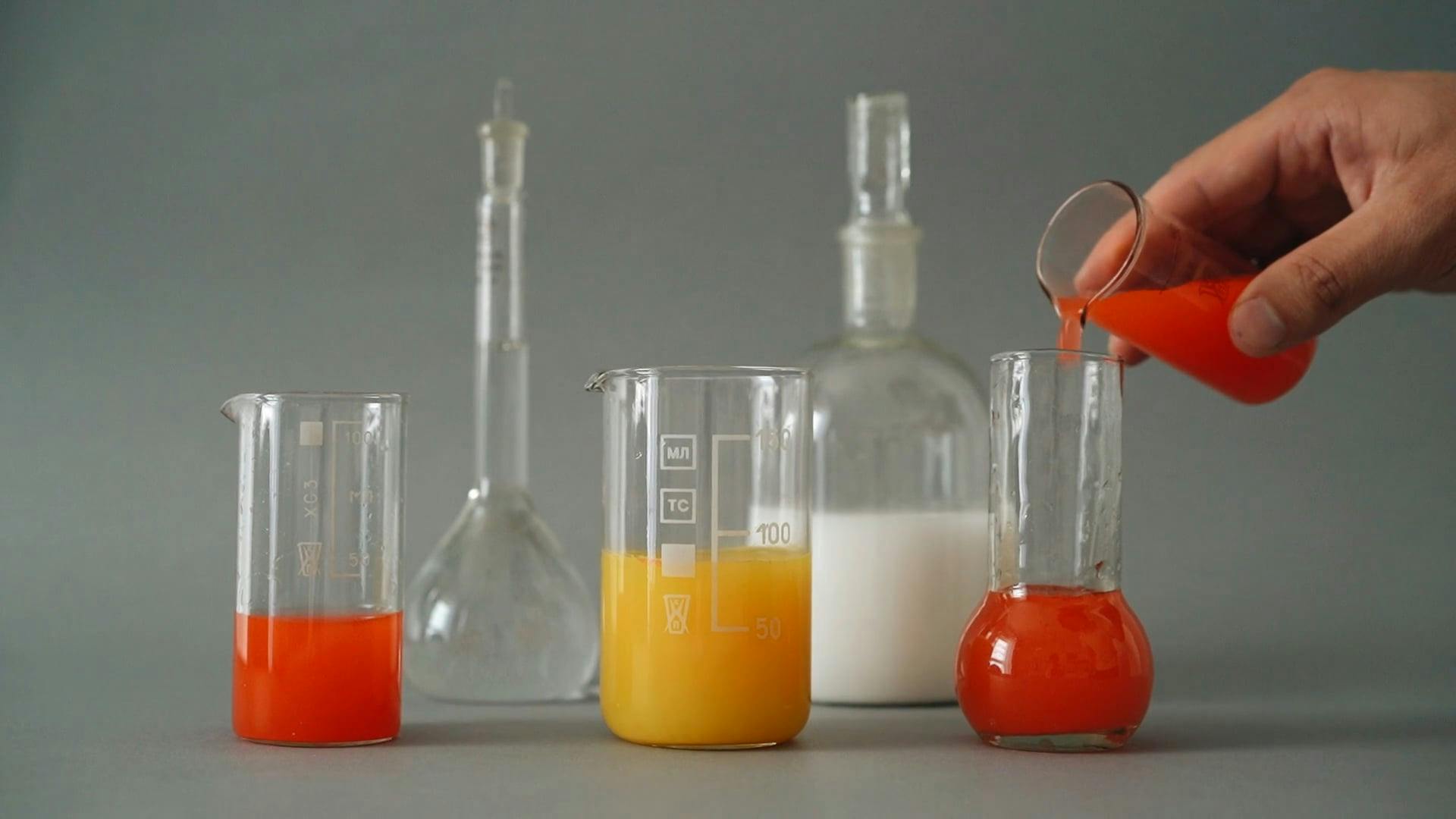 A Person Mixing Liquids on Glass Containers · Free Stock Video