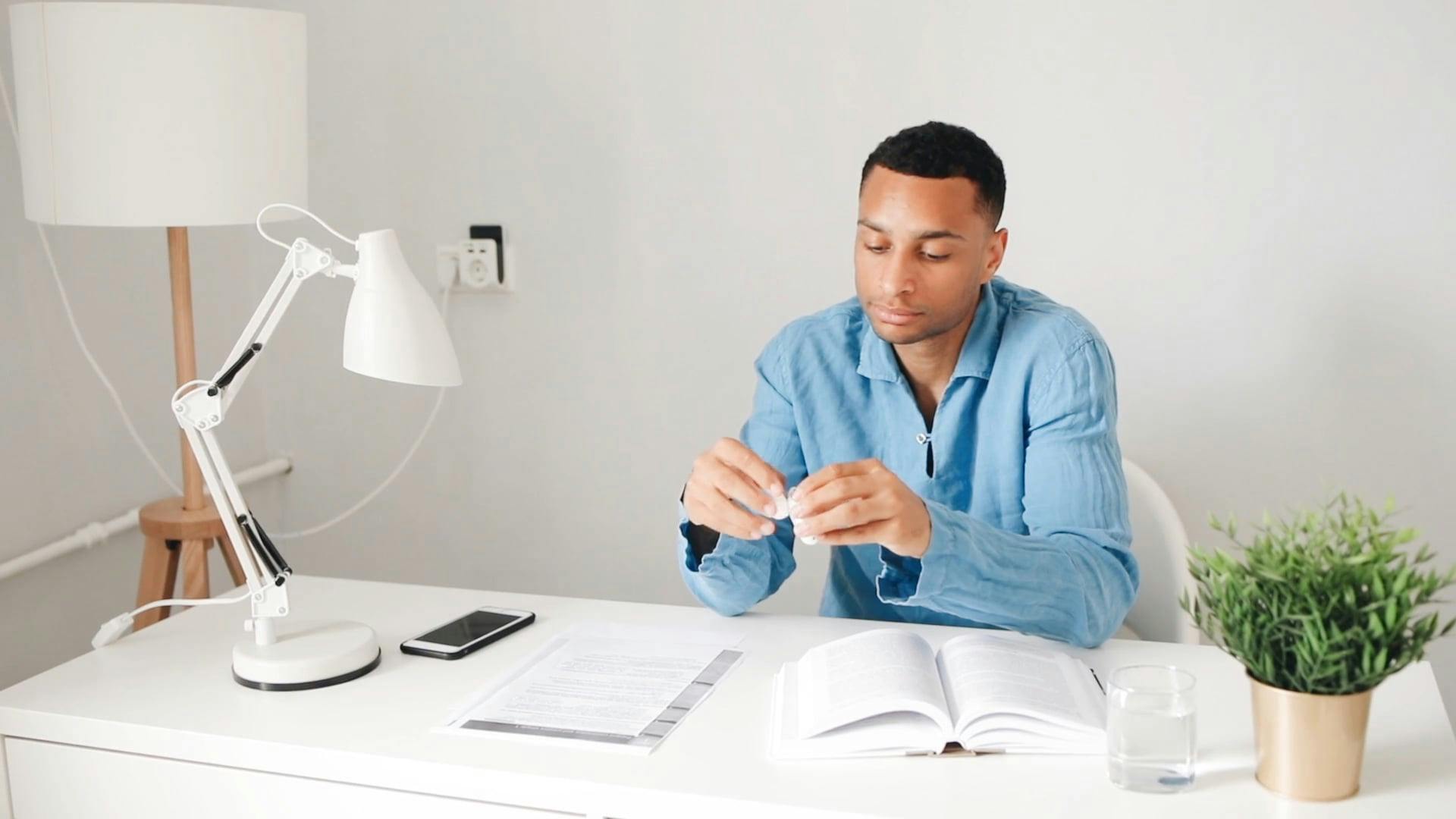 A Young Man Wearing Wireless Headphones before Reading a Book · Free ...