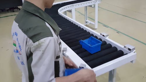 Man Working On Conveyor Machine