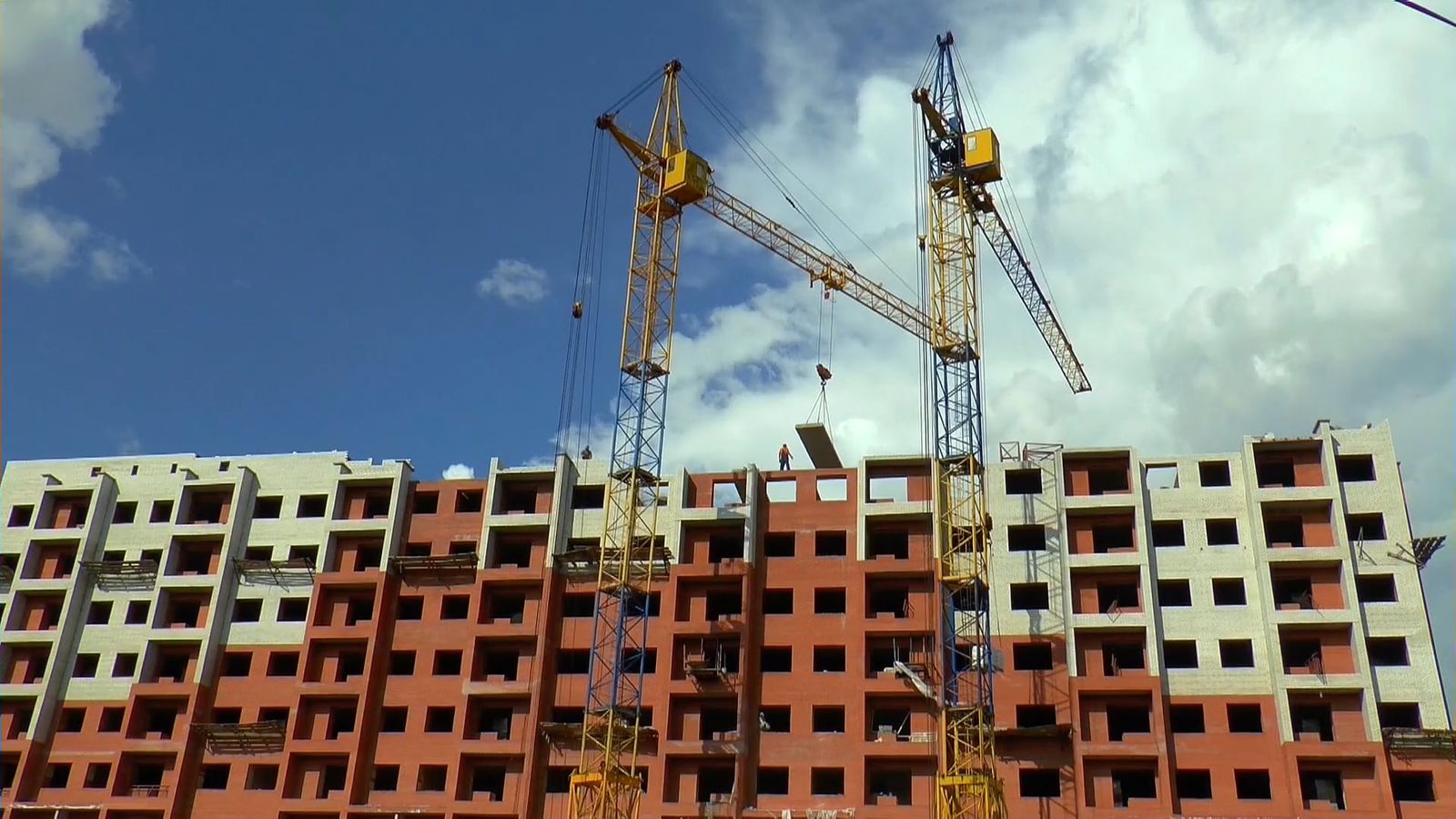 A construction site with cranes and workers