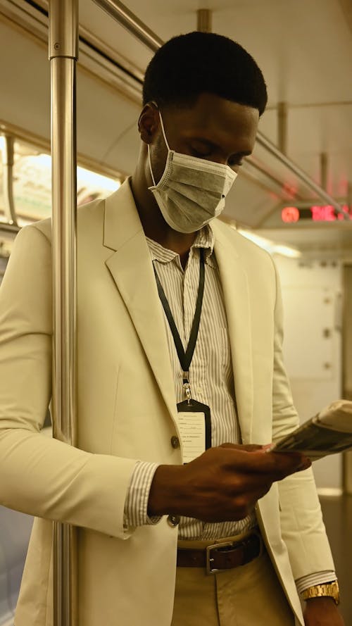Man Reading Newspaper Inside the Train