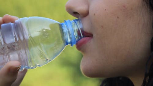 Teen boy drinking water outdoors Stock Video Footage by ©VaLiza #199836514