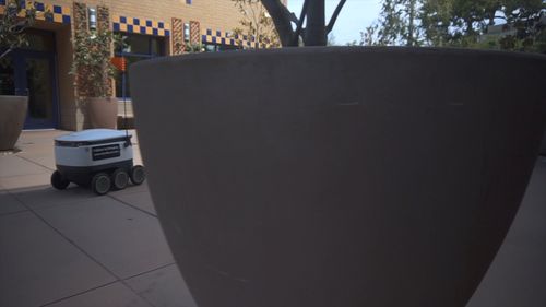 Robot Rover Moving In Monument With Visitors A Robotic Rover on the Move · Free Stock Video
