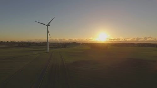 Wind Turbine on a Field at Sunrise