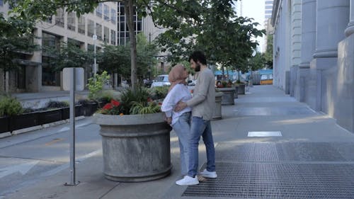 Man and Woman Being Affectionate to Each Other While in a Sidewalk