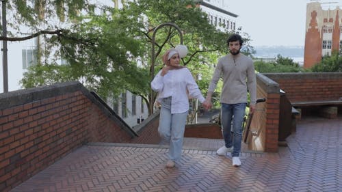 Couple Holding Hands While Walking