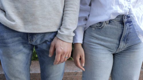 Couple Holding Hands While Looking at Each Other