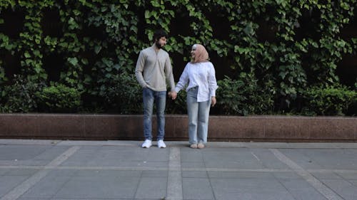 Couple Holding Hands While Having a Conversation