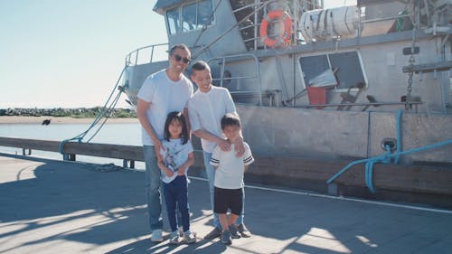 A Happy Family Standing Together near the Ship