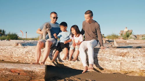 Happy Family Sitting on a Log