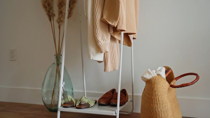 Cream knits and pampas grass on a clothing rack