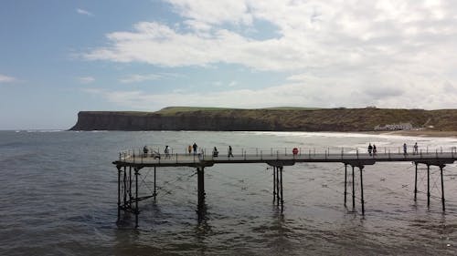 Drone Footage of People Walking on Pier