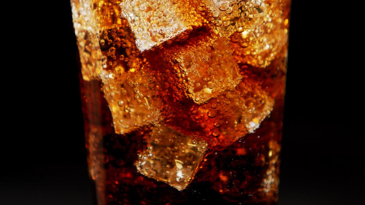 Extreme Close up of Cola being Poured into a Glass Filled with Ice Free ...