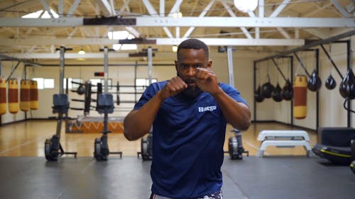 Brawny Man Practicing Kickboxing