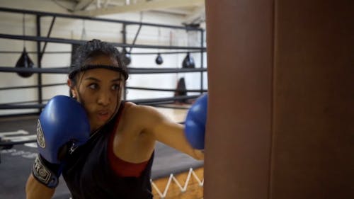 A Woman Punching Using a Boxing Gloves