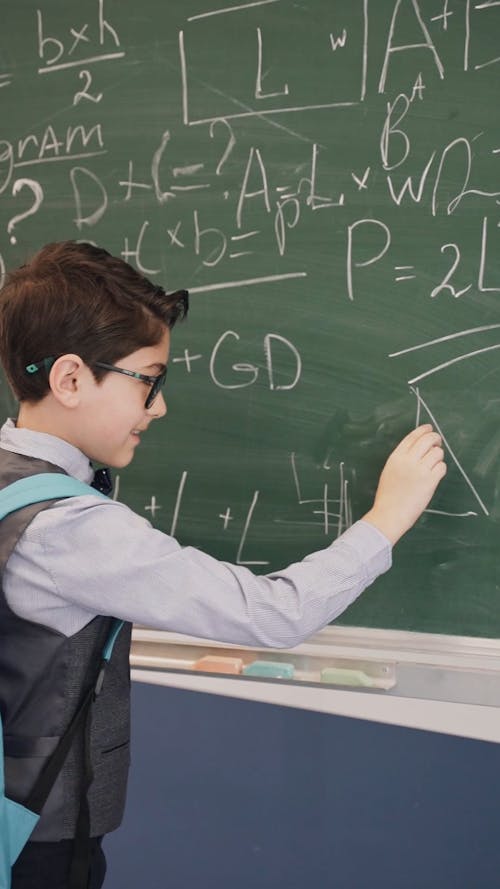 Boy Writing on Blackboard
