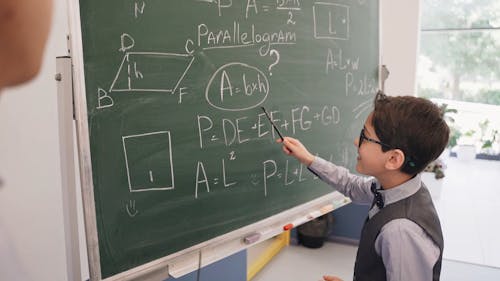 Boy Looking at a Problem In the Blackboard