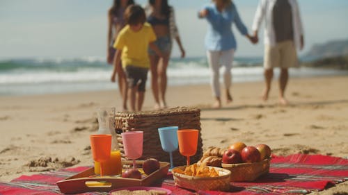 Family Approaching Picnic In a Beach