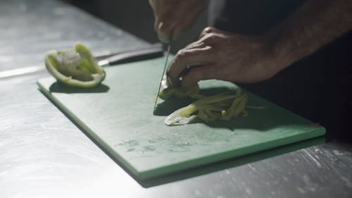 A Person Chopping a Bell Pepper 