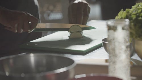 A Person Slicing a Vegetable 