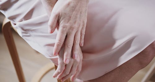 Elderly Woman Touching her Skin