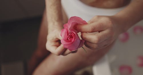 A Woman Putting Flower Petals in the Bathtub