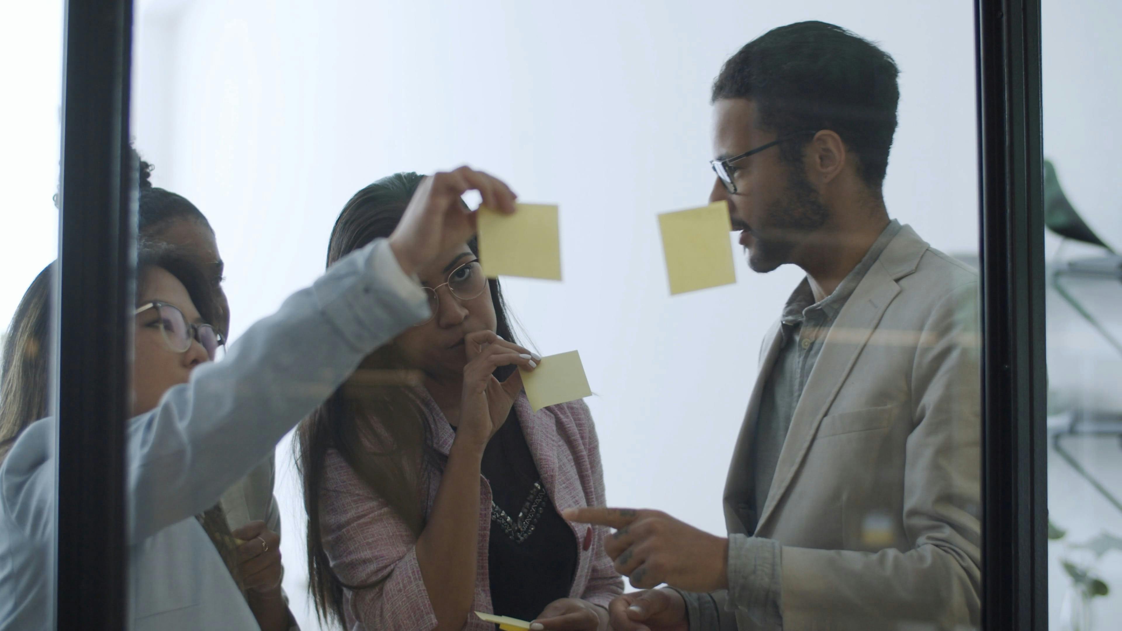 People Sticking Adhesive Notes on Glass · Free Stock Video