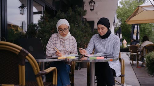 Women Remote Working Together at a Cafe