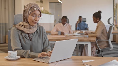 Woman Wearing Hijab Using a Laptop