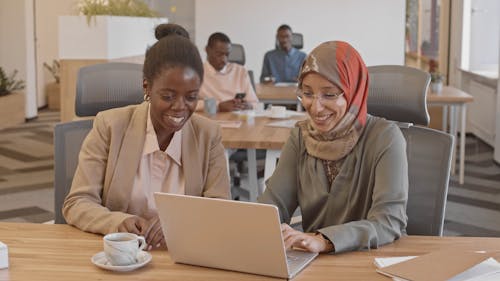 Woman Wearing Hijab Using a Laptop at the Office