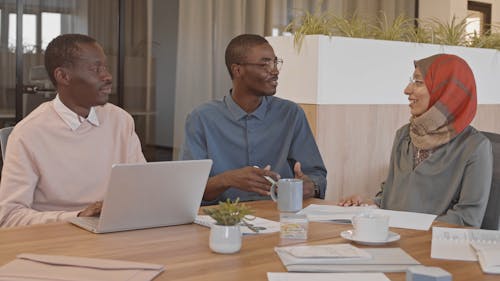 Man Wearing Eyeglasses Talking in a Meeting