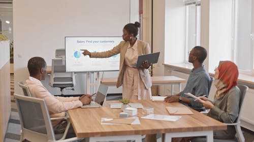 Woman Presenting in a Meeting