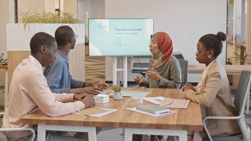 Woman Wearing Hijab Talking in a Meeting