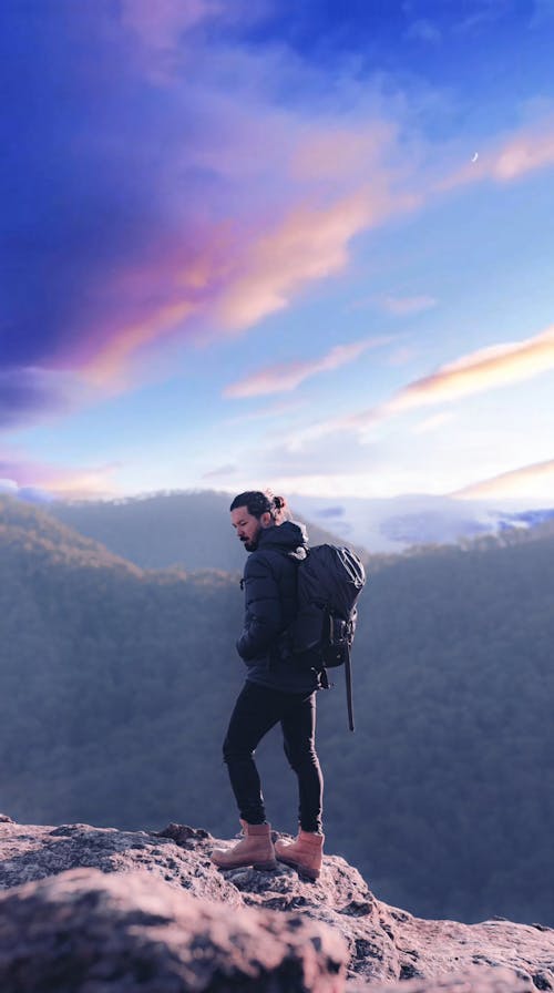 A Man Standing Still on a Cliff Edge