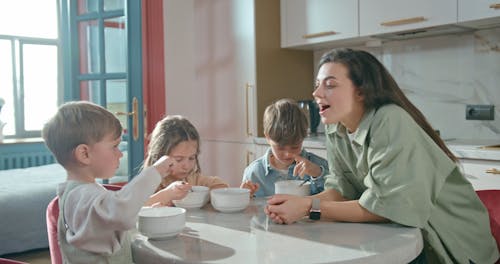 Boy Feeding a Woman with a Spoon