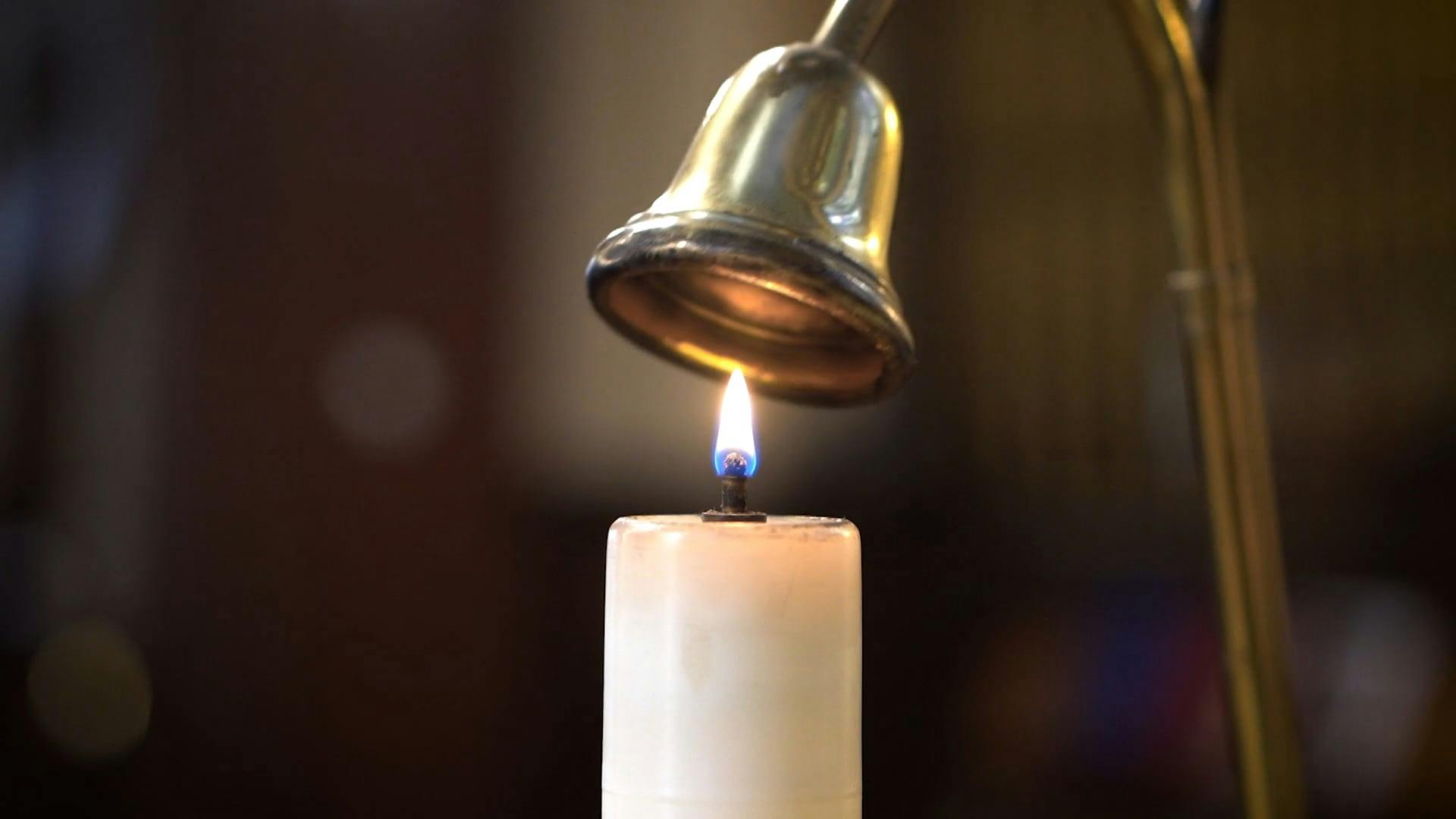 Putting Out Flame from a Lighted Candle Using a Bell Snuffer · Free