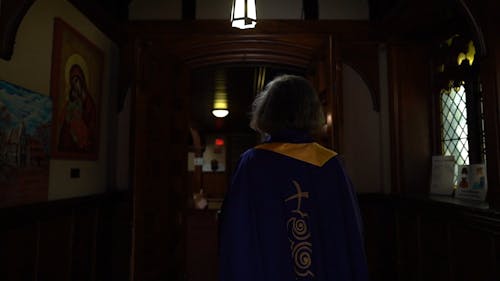Back View of a Priest Walking Going to the Altar