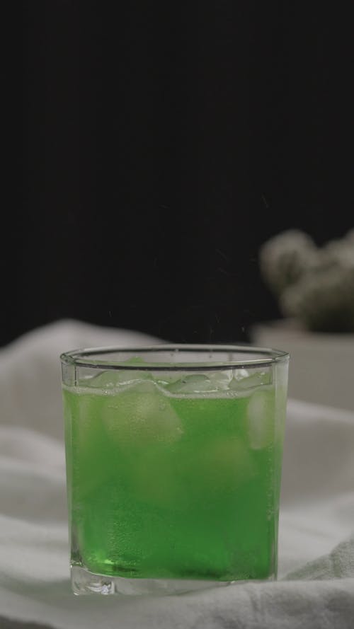 Close up of Green Soda in a Glass with Ice