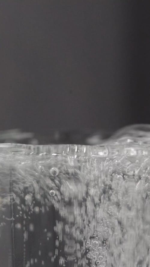 A Person Pouring Water in the Glass